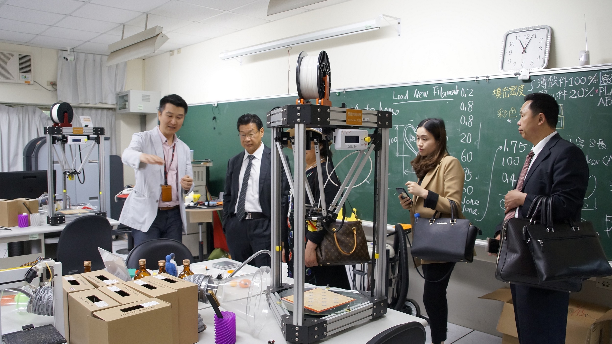 創意設計系胡文和主任（左）向何濟董事長（左二）等人介紹全台校園第一座旗艦型3D列印設計中心