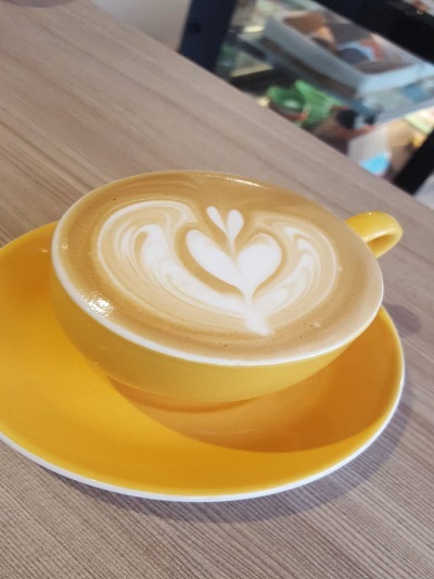 李雅綺利用奶泡在咖啡上拉花作畫，好看又好喝。